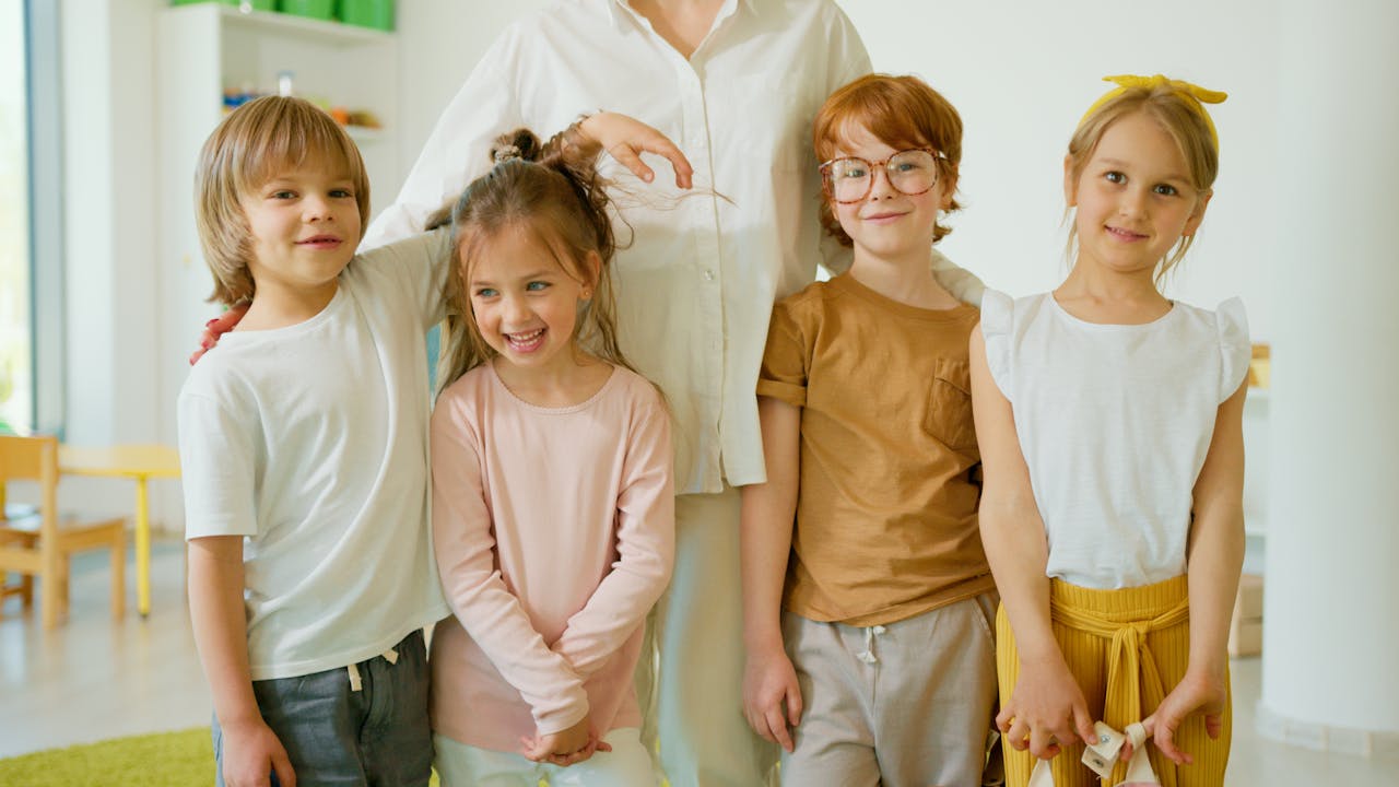 Joyful children posing indoors, smiling together in a learning environment.